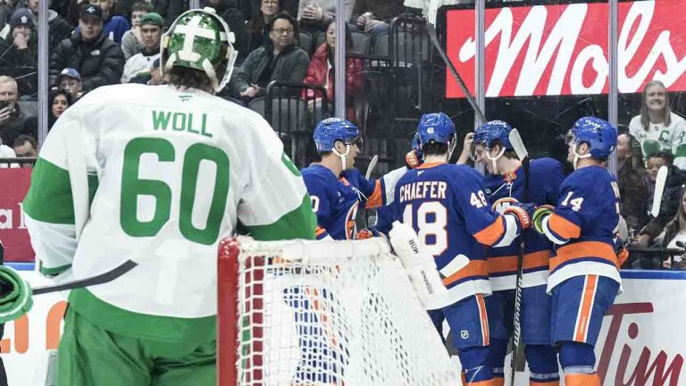 Maple Leafs goaltender Joseph Woll (60) looks on as New York Islanders players celebrate their second goal in Toronto on Tuesday March 17, 2026. (Chris Young/CP)