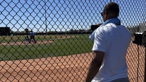 MIke Batiste looks behind the cage as his son, Mike Batiste Jr., plays a baseball game (Michael Grange/Sportsnet)