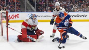 Florida Panthers goalie Sergei Bobrovsky (72) makes the save as Gustav Forsling (42) and Edmonton Oilers' Kasperi Kapanen (42) battle for the rebound during second period NHL action, in Edmonton on Thursday March 19, 2026. (Jason Franson/CP)
