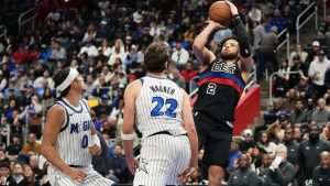 Detroit Pistons guard Cade Cunningham, right, looks to shoot against Orlando Magic guard Anthony Black, left, and forward Franz Wagner (22) during the second half of an NBA Cup basketball game Friday, Nov. 28, 2025, in Detroit. (Ryan Sun/AP)
