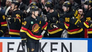 Vancouver Canucks' Elias Pettersson (40) celebrates his goal against the Florida Panthers with his teammates during the first period of an NHL hockey game in Vancouver, on Tuesday, March 17, 2026. (Ethan Cairns/CP)