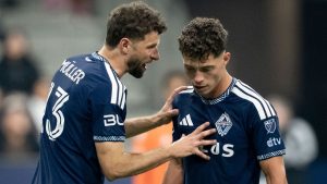 Vancouver Whitecaps' Thomas Muller, left, talks with Sebastian Berhalter (16) during the second half of an MLS soccer match against Real Salt Lake in Vancouver, on Saturday, February 21, 2026. (Ethan Cairns/CP)