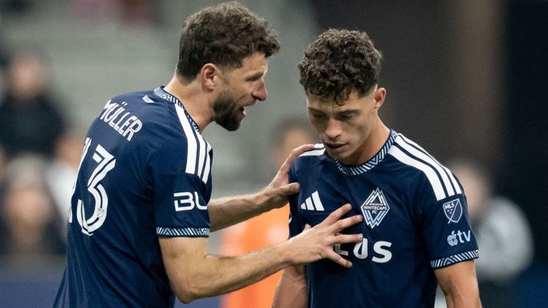Vancouver Whitecaps' Thomas Muller, left, talks with Sebastian Berhalter (16) during the second half of an MLS soccer match against Real Salt Lake in Vancouver, on Saturday, February 21, 2026. (Ethan Cairns/CP)