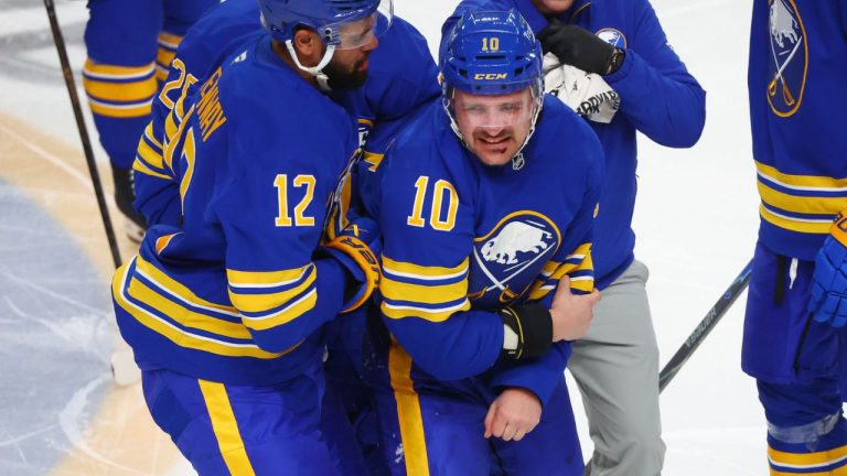 Buffalo Sabres centre Sam Carrick (10) is helped off the ice after a fight with New York Islanders left wing Anders Lee (27) during the third period of an NHL hockey game Tuesday, March 31, 2026, in Buffalo, N.Y. (Jeffrey T. Barnes/AP Photo)