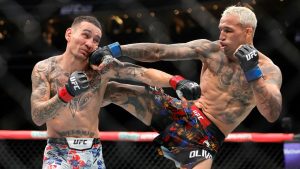 Charles Oliveira, right, punches Max Holloway in a lightweight fight during UFC 326 Saturday, March 7, 2026, in Las Vegas. (Steve Marcus/Las Vegas Sun via AP)/Las Vegas Sun via AP)