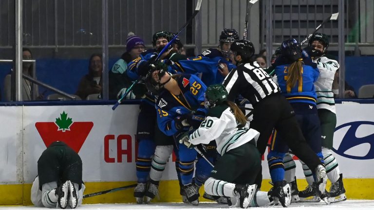 Toronto Sceptres' Clara Van Wieren (25) is roughed up after checking Boston Fleet's Sophie Shirley, left, during third period PWHL hockey action in Toronto on Friday, March 27, 2026. (Jon Blacker/CP)