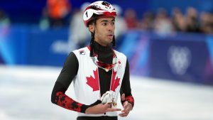 Canada's William Dandjinou finishes fourth in the men's 1,000 metre short track speedskating finals at the 2026 Winter Olympics, in Milan, on Thursday, February 12, 2026. (Darryl Dyck/CP)