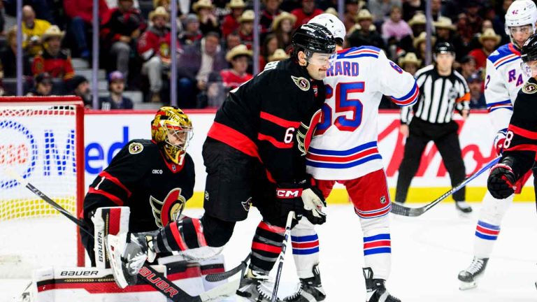 Ottawa Senators' Dennis Gilbert (6) lifts his leg to avoid a puck in front of goaltender Leevi Merilainen (1) during first period NHL hockey action against the New York Rangers. (Spencer Colby/THE CANADIAN PRESS)