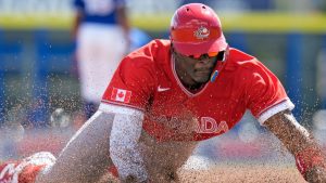 Canada's Denzel Clarke slides head first into third base on a single by Tyler Black off Toronto Blue Jays pitcher Angel Bastardo during the third inning of an exhibition baseball game Tuesday, March 3, 2026, in Dunedin, Fla. (Chris O'Meara/AP)