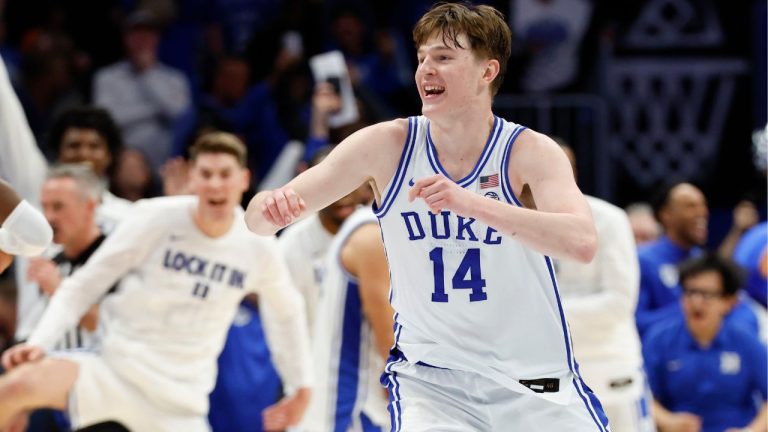Duke guard Nikolas Khamenia (14) celebrates as Duke defeats Virginia in an NCAA college basketball game in the championship of the Atlantic Coast Conference tournament in Charlotte, N.C., Saturday, March 14, 2026. (Nell Redmond/AP Photo)