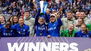 Chelsea's Erin Cuthbert, centre left, and Millie Bright, centre right, lift the trophy with their team mates as they celebrate after winning the Women's League Cup final, in Bristol, England, Sunday, March 15, 2026. (Nick Potts/PA via AP)