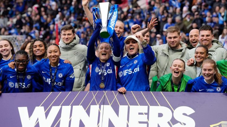 Chelsea's Erin Cuthbert, centre left, and Millie Bright, centre right, lift the trophy with their team mates as they celebrate after winning the Women's League Cup final, in Bristol, England, Sunday, March 15, 2026. (Nick Potts/PA via AP)
