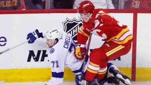 Calgary Flames' Tyson Gross knocks down Tampa Bay Lightning's Anthony Cirelli during first period NHL action in Calgary, Sunday, March 22, 2026. (THE CANADIAN PRESS/Larry MacDougal)