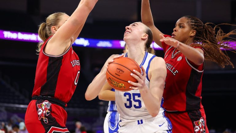Duke forward Toby Fournier (35) drives to the basket against Louisville forwards Laura Ziegler, left, and MacKenly Randolph, right, during the second half of an NCAA college basketball game in the championship of the Atlantic Coast Conference tournament, Sunday, March 8, 2026, in Duluth, Ga. (Colin Hubbard/AP Photo)