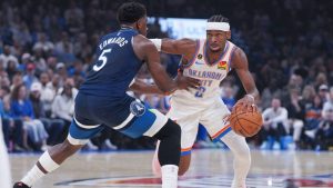 Oklahoma City Thunder guard Shai Gilgeous-Alexander, right, pushes past Minnesota Timberwolves guard Anthony Edwards (5) during the first half of an NBA basketball game, Sunday, March 15, 2026, in Oklahoma City. (Kyle Phillips/AP)