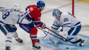 Toronto Maple Leafs goaltender Joseph Woll (60) stops a shot by Montreal Canadiens' Jake Evans (71) as Maple Leafs' Troy Stecher (28) defends during second period NHL hockey action in Montreal on Tuesday, March 10, 2026. (Christinne Muschi/CP)