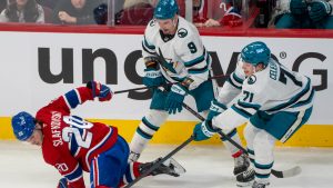 San Jose Sharks' Macklin Celebrini (71) is called for cross checking against Montreal Canadiens' Juraj Slafkovsky (20) during first period NHL hockey action in Montreal on Saturday, March 14, 2026. (Christinne Muschi/CP)
