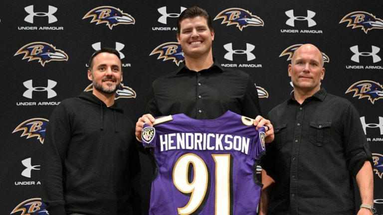 Baltimore Ravens, left to right, head coach Jesse Minter, defensive end Trey Hendrickson and general manager Eric DeCosta pose for a picture during an introductory NFL football press conference Friday, March 13, 2026, in Owings Mills, Md. (Gail Burton/AP)