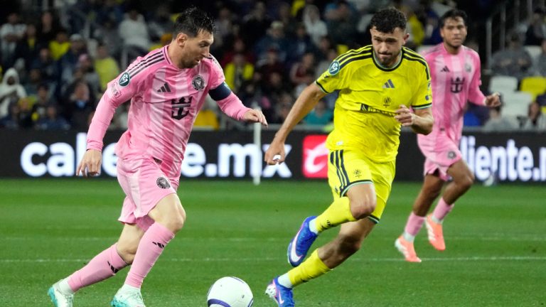 Inter Miami forward Lionel Messi, left, moves the ball against Nashville SC midfielder Patrick Yazbek in the first half of a CONCACAF Champions Cup Round of 16 soccer match Wednesday, March 11, 2026, in Nashville, Tenn. (Mark Humphrey/AP)