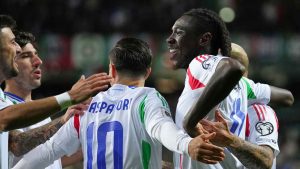 Italy's Moise Kean, right, celebrates with teammates after scoring the opening goal during a World Cup 2026 group I qualifying soccer match between Estonia and Italy in Tallinn, Estonia. (Sergei Grits/AP)