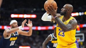 Los Angeles Lakers forward LeBron James, right, goes up for a field goal to surpass Kareem Abdul-Jabbar's record of 15,837 to become the NBA's all-time leader in field goals as Denver Nuggets forward Zeke Nnaji defendns in the first half of an NBA basketball game Thursday, March 5, 2026, in Denver. (David Zalubowski/AP)