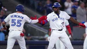 Toronto Blue Jays outfielder Jesus Sanchez (12) celebrates his two run homer with teammate Tyler Heineman (55) while playing against the Athletics during third inning American League baseball action in Toronto on Sunday, March 29, 2026. (Nathan Denette/CP)