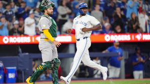 Toronto Blue Jays right fielder Jesús Sánchez (12) scores a run in the seventh inning MLB baseball action against the Athletics in Toronto on Saturday, March 28, 2026. (Frank Gunn/CP)