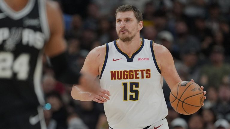 Denver Nuggets centre Nikola Jokic (15) moves the ball up court against the San Antonio Spurs during the first half of an NBA basketball game in San Antonio, Thursday, March 12, 2026. (Eric Gay/AP Photo)