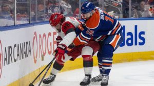 Carolina Hurricanes' William Carrier (28) and Edmonton Oilers' Jason Dickinson (16) battle for the puck during first period NHL action, in Edmonton on Friday March 6, 2026. (Jason Franson/THE CANADIAN PRESS)