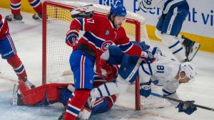 Toronto Maple Leafs' Dakota Joshua (81) crashes into Montreal Canadiens goaltender Jakub Dobes (75) as Canadiens' Josh Anderson (17) defends during first period NHL hockey action in Montreal on Tuesday, March 10, 2026. (Christinne Muschi/CP)