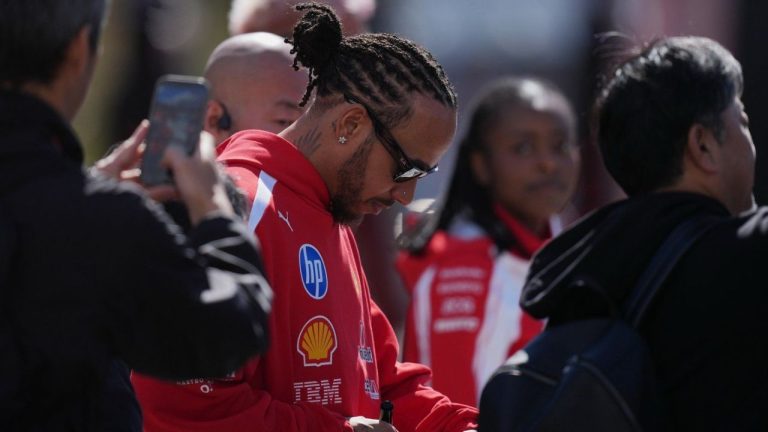Ferrari driver Lewis Hamilton of Britain gives an autograph in Suzuka, central Japan, Thursday, March 26, 2026, ahead of Sunday's Japanese Formula One Grand Prix race. (Hiro Komae/AP)