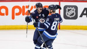 Winnipeg Jets' Mark Scheifele and Kyle Connor celebrate Connor's goal against the Toronto Maple Leafs during second period NHL action in Winnipeg, Saturday, January 17, 2026. (THE CANADIAN PRESS/John Woods)