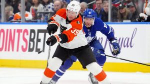 Philadelphia Flyers Matvei Michkov (39) makes a pass under pressure from Toronto Maple Leafs John Tavares (91) during first period NHL hockey action in Toronto, Monday, March 2, 2026. (Frank Gunn/CP)