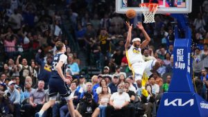 Golden State Warriors guard Moses Moody, right, reacts while suffering an injury as Dallas Mavericks forward Cooper Flagg (32) looks on during overtime of an NBA basketball game Monday, March 23, 2026, in Dallas. (Julio Cortez/AP)