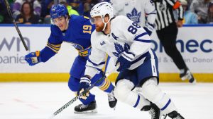 Toronto Maple Leafs right wing William Nylander (88) carries the puck past Buffalo Sabres center Peyton Krebs (19) during the first period of an NHL hockey game Saturday, March 14, 2026, in Buffalo, N.Y. (Jeffrey T. Barnes/CP)