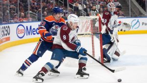 Colorado Avalanche's Cale Makar (8) and Edmonton Oilers' Ryan Nugent-Hopkins (93) battle for the puck as goalie MacKenzie Blackwood (39) watches during second period NHL action in Edmonton on Friday, February 7, 2025. (Jason Franson/CP)