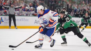 Edmonton Oilers right wing Kasperi Kapanen (42) skates with the puck against Dallas Stars right wing Arttu Hyry (25) during the first period of an NHL hockey game Thursday, March 12, 2026, in Dallas. (LM Otero/AP Photo)