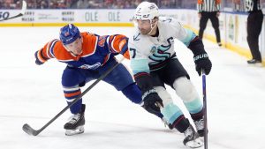 Seattle Kraken's Jordan Eberle (7) and Edmonton Oilers' Ty Emberson (49) battle for the puck during first period NHL action, in Edmonton on Tuesday, March 31, 2026. (Jason Franson/THE CANADIAN PRESS)