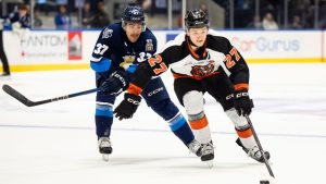 Medicine Hat Tigers' Bryce Pickford (27) moves the puck forward while defended by Rimouski Oceanic's Mael St-Denis (37) during second period Memorial Cup hockey action in Rimouski, Que., on Friday, May 23, 2025. (Christopher Katsarov/THE CANADIAN PRESS)
