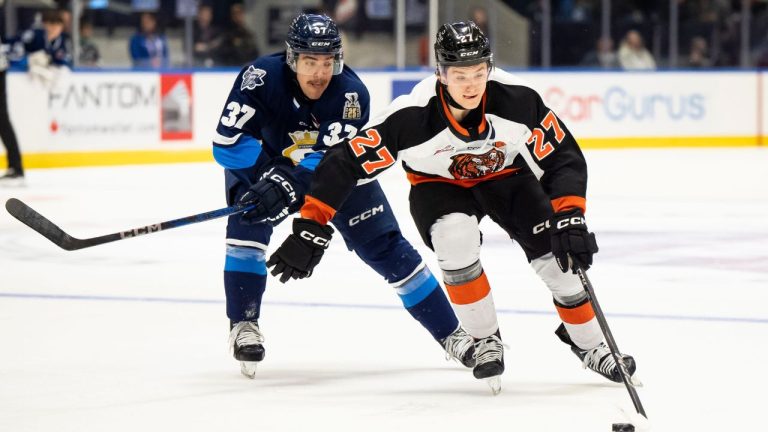 Medicine Hat Tigers' Bryce Pickford (27) moves the puck forward while defended by Rimouski Oceanic's Mael St-Denis (37) during second period Memorial Cup hockey action in Rimouski, Que., on Friday, May 23, 2025. (Christopher Katsarov/THE CANADIAN PRESS)