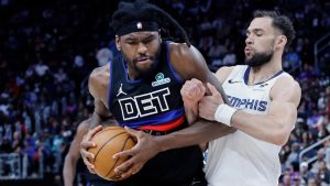 Detroit Pistons forward Isaiah Stewart, left, is tied up by Memphis Grizzlies guard Ty Jerome, right, during the second half of an NBA basketball game Friday, March 13, 2026, in Detroit. (Duane Burleson/AP Photo)