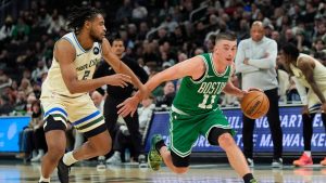 Boston Celtics' Payton Pritchard (11) drives to the basket against Milwaukee Bucks' Cam Thomas during the second half of an NBA basketball game, Monday, March 2, 2026, in Milwaukee. (Aaron Gash/AP)