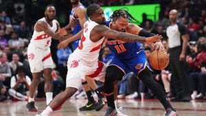 Toronto Raptors' Jamal Shead battles for the ball with New York Knicks' Jalen Brunson during first half NBA action in Toronto on Tuesday, March 3, 2026. (THE CANADIAN PRESS/Nathan Denette)