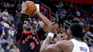 Toronto Raptors forward RJ Barrett (9) takes a shot against Detroit Pistons guard Daniss Jenkins, back, and center Jalen Duren (0) during the first half of an NBA basketball game Tuesday, March 31, 2026, in Detroit. (Duane Burleson/AP Photo)