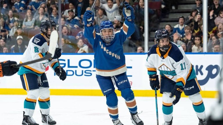 Vancouver Goldeneyes' Anna Segedi (51) celebrates her goal as New York Sirens' Nicole Vallario (11) watches the goal during the first period of a PWHL hockey game in Vancouver, on Wednesday, March 18, 2026. (Ethan Cairns/CP)