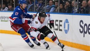 New York Rangers' Will Borgen (17) fights for control of the puck with Ottawa Senators' Fabian Zetterlund (20) during the first period of an NHL hockey game Monday, March 23, 2026, in New York. (Frank Franklin II/AP Photo)