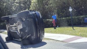 Golfer Tiger Woods stands by his overturned vehicle in Jupiter Island, Fla., on Friday, March 27, 2026. (Jason Oteri/AP)
