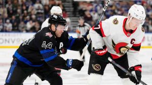 Ottawa Senators' Brady Tkachuk (7) protects the puck from Toronto Maple Leafs' Morgan Rielly (44) and Auston Matthews (34) during first period NHL hockey action. (Frank Gunn/THE CANADIAN PRESS)