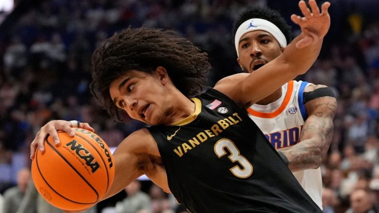 Vanderbilt guard Tyler Tanner (3) is guarded by Florida guard Boogie Fland, right, during the second half of an NCAA college basketball game in the semifinals of the Southeastern Conference tournament Saturday, March 14, 2026, in Nashville, Tenn. (George Walker IV/AP)