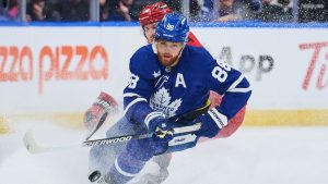 Toronto Maple Leafs' William Nylander battles for the puck with Carolina Hurricanes' Jaccob Slavin during first period NHL action in Toronto, on Friday, March 20, 2026. (THE CANADIAN PRESS/Sammy Kogan)